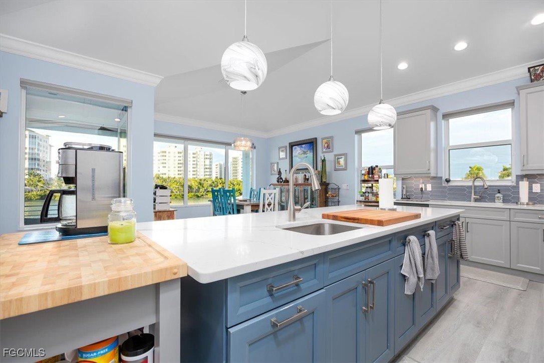 8425 Lagoon Road Fort Myers Beach, FL 33931 - Photo 13 of 49 an open kitchen with a sink and dishwasher with wooden cabinets
