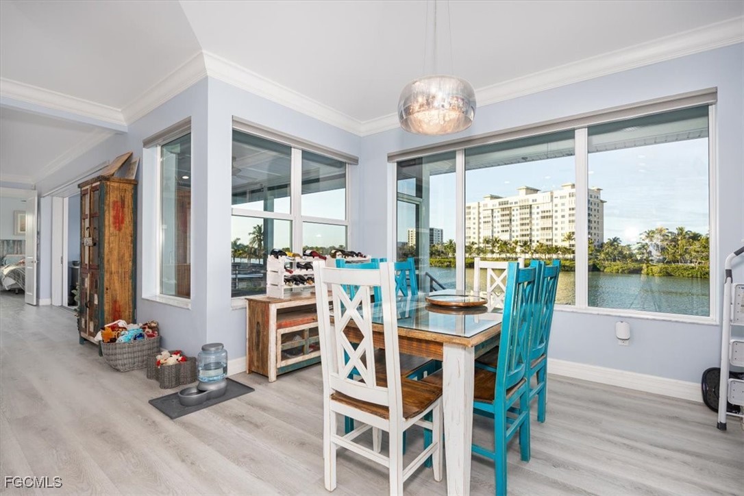 8425 Lagoon Road Fort Myers Beach, FL 33931 - Photo 15 of 49 a view of a dining room with furniture window and wooden floor