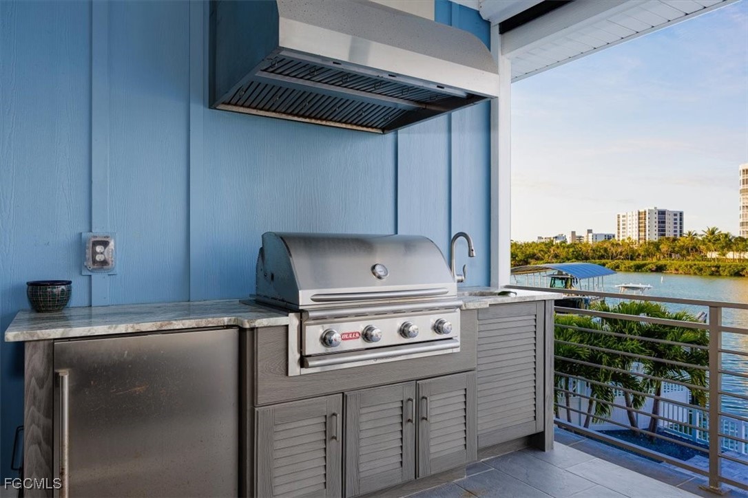 8425 Lagoon Road Fort Myers Beach, FL 33931 - Photo 18 of 49 a kitchen with a stove and cabinets