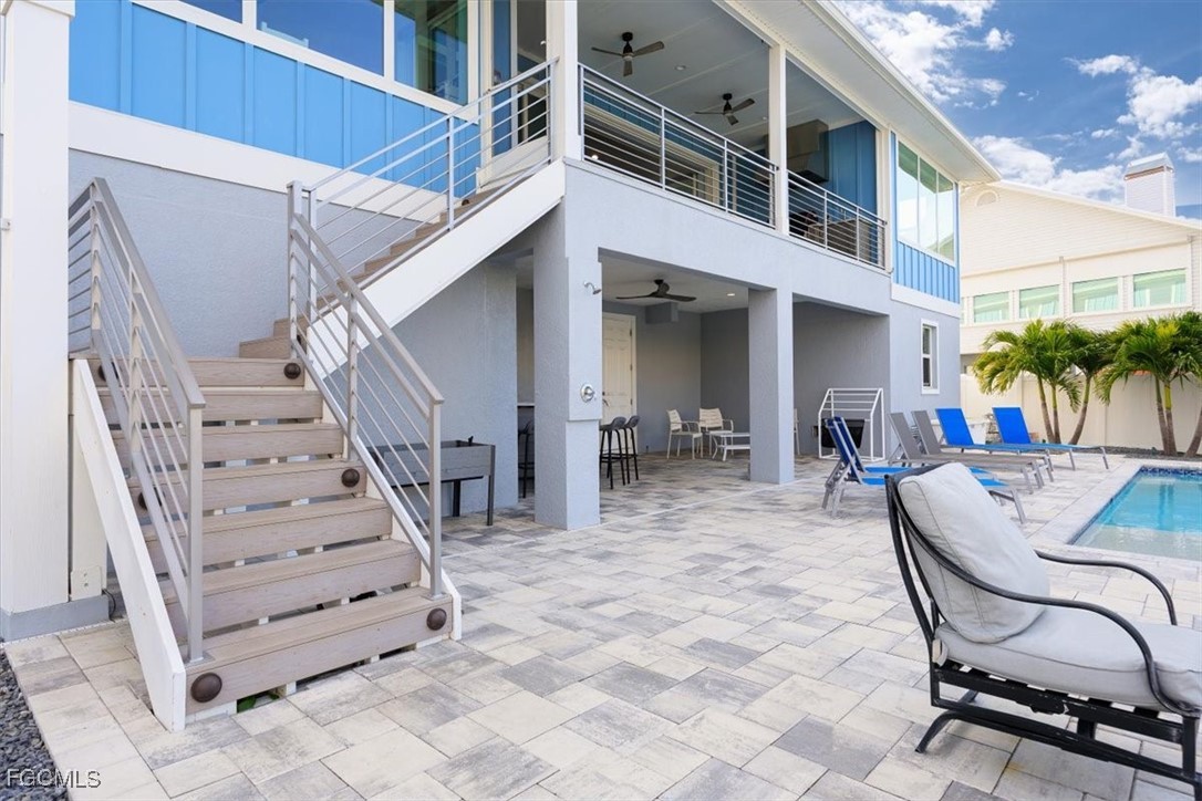 8425 Lagoon Road Fort Myers Beach, FL 33931 - Photo 19 of 49 a view of a patio with a table and chairs