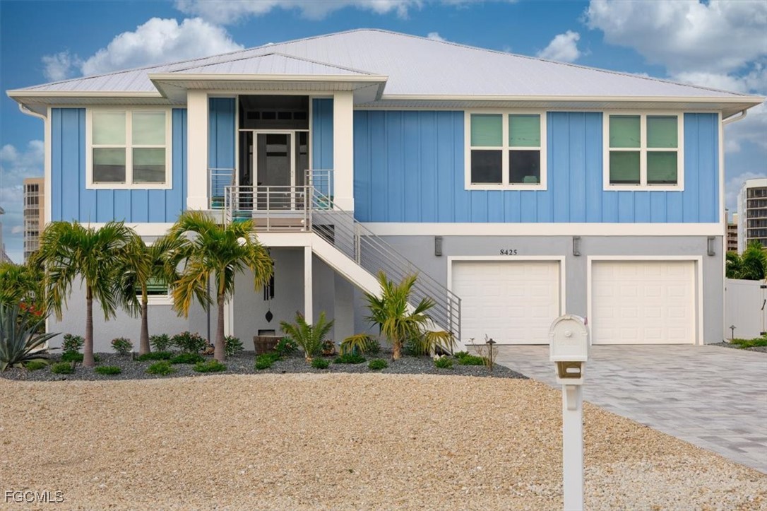 8425 Lagoon Road Fort Myers Beach, FL 33931 - Photo 2 of 49 front view of a brick house with a yard