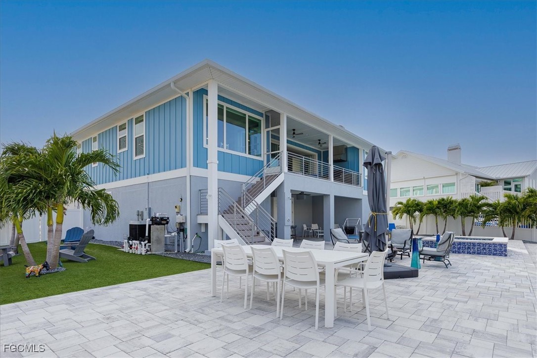 8425 Lagoon Road Fort Myers Beach, FL 33931 - Photo 22 of 49 a view of a patio with a table and chairs