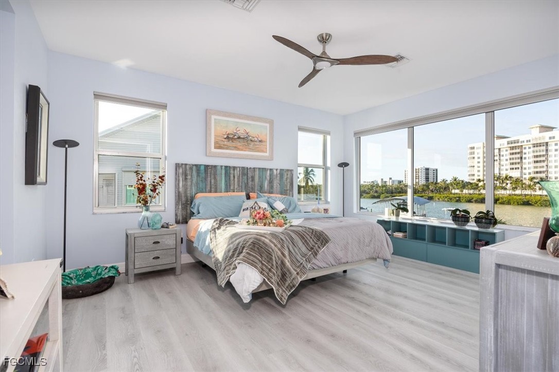 8425 Lagoon Road Fort Myers Beach, FL 33931 - Photo 24 of 49 a bedroom with a large bed and a large window