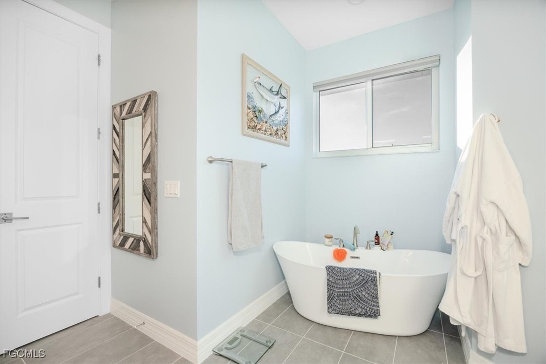 8425 Lagoon Road Fort Myers Beach, FL 33931 - Photo 28 of 49 a bathroom with a bathtub and shower