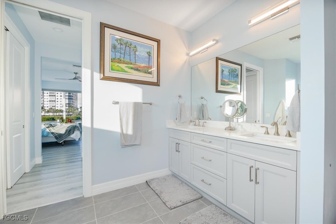 8425 Lagoon Road Fort Myers Beach, FL 33931 - Photo 29 of 49 a en suite bathroom with a granite countertop sink and mirror