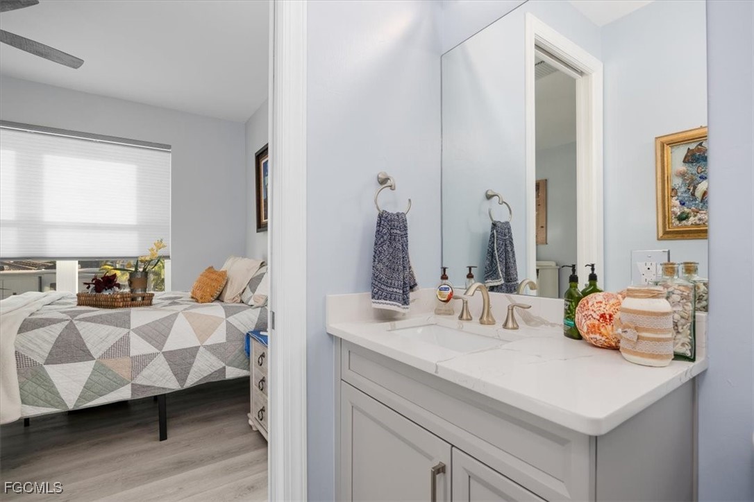 8425 Lagoon Road Fort Myers Beach, FL 33931 - Photo 33 of 49 a en suite bathroom with sink and mirror