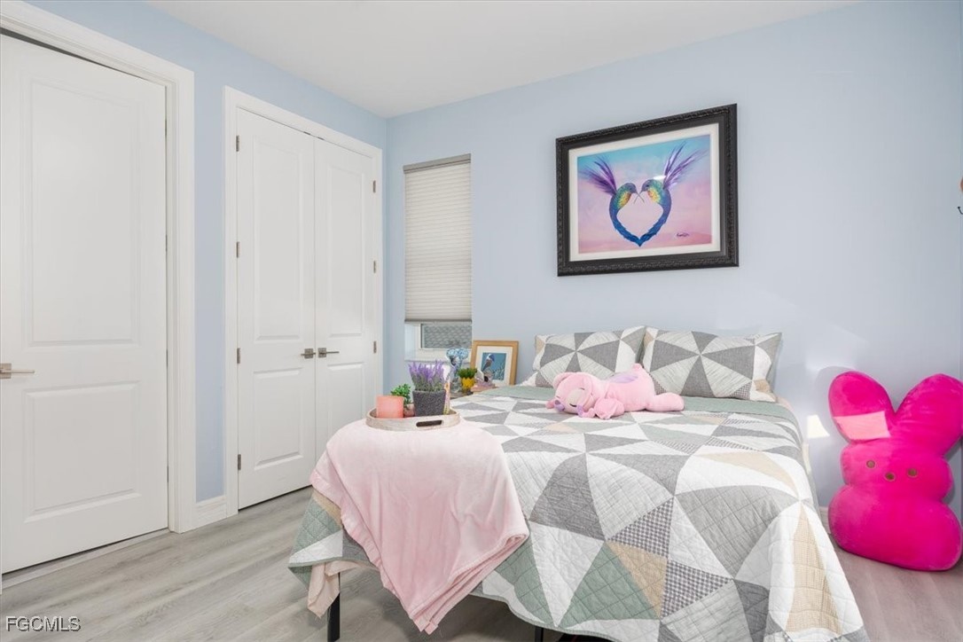 8425 Lagoon Road Fort Myers Beach, FL 33931 - Photo 35 of 49 a bedroom with a bed and a painting on the wall