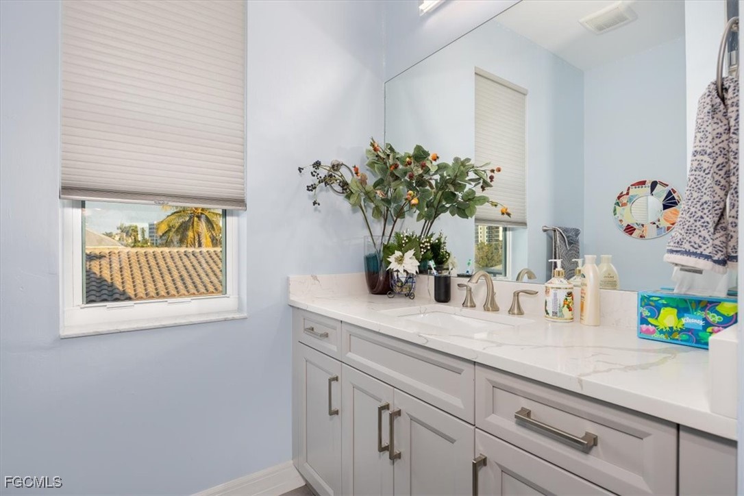 8425 Lagoon Road Fort Myers Beach, FL 33931 - Photo 36 of 49 a bathroom with a sink a vanity and a mirror