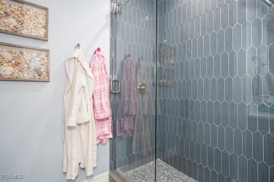 8425 Lagoon Road Fort Myers Beach, FL 33931 - Photo 37 of 49 a bathroom with a shower curtain