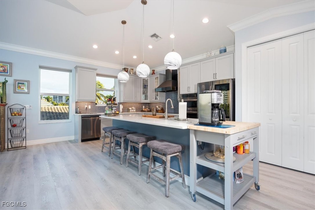 8425 Lagoon Road Fort Myers Beach, FL 33931 - Photo 9 of 49 a kitchen with kitchen island stainless steel appliances a sink and cabinets