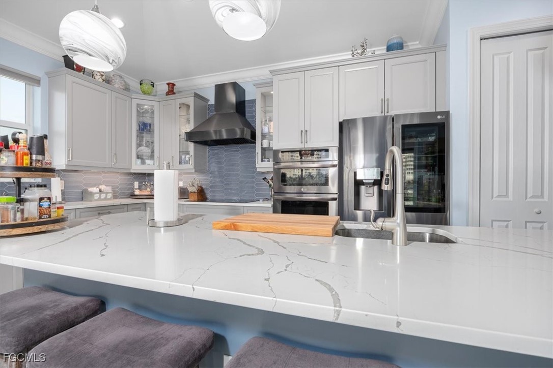 8425 Lagoon Road Fort Myers Beach, FL 33931 - Photo 10 of 49 a kitchen with stainless steel appliances granite countertop a sink and a refrigerator