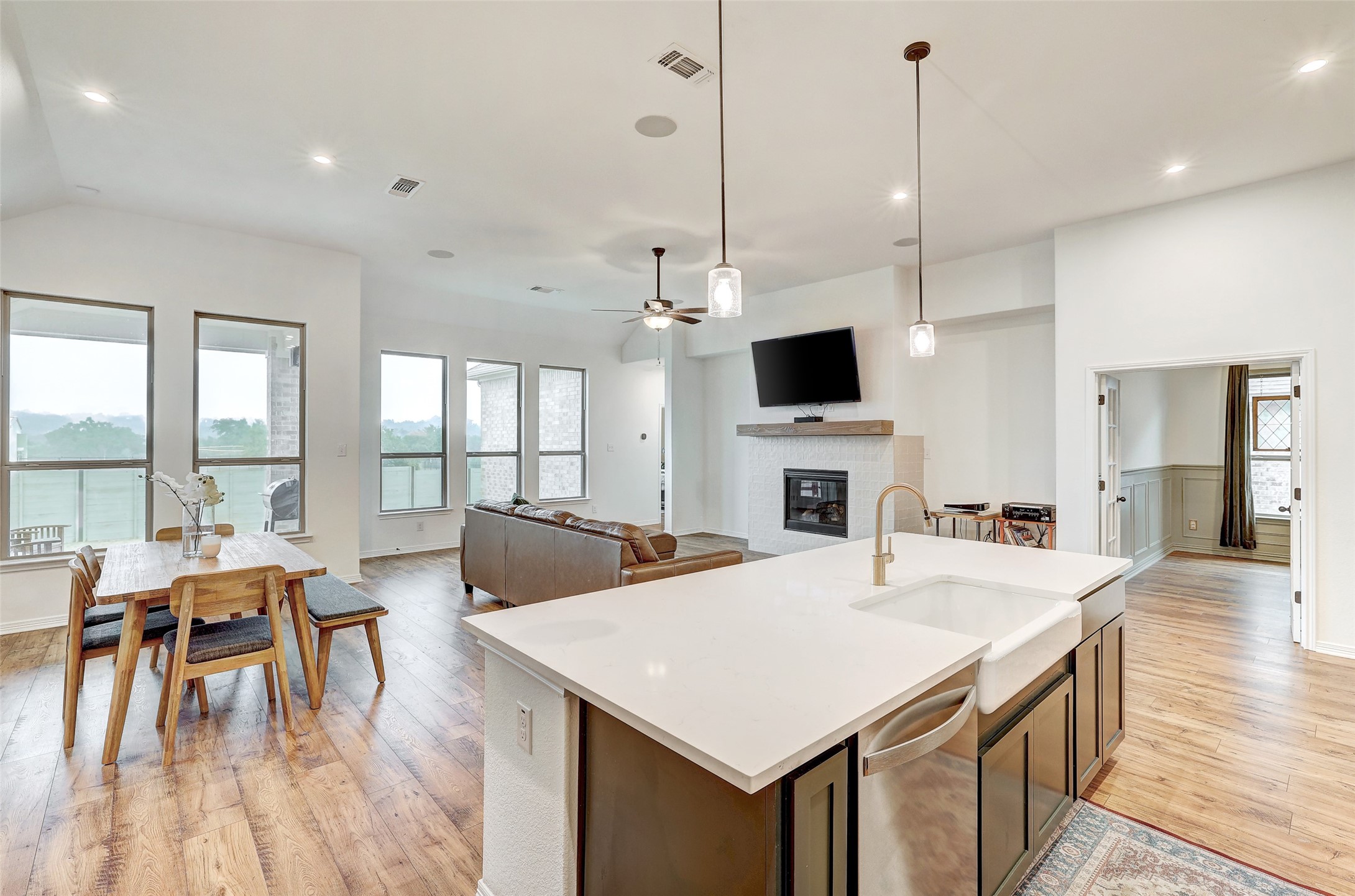 1117 Spring Gulch Lane Georgetown, TX 78628 - Photo 7 of 39 An open-concept living space with sleek flooring and a contemporary fireplace.