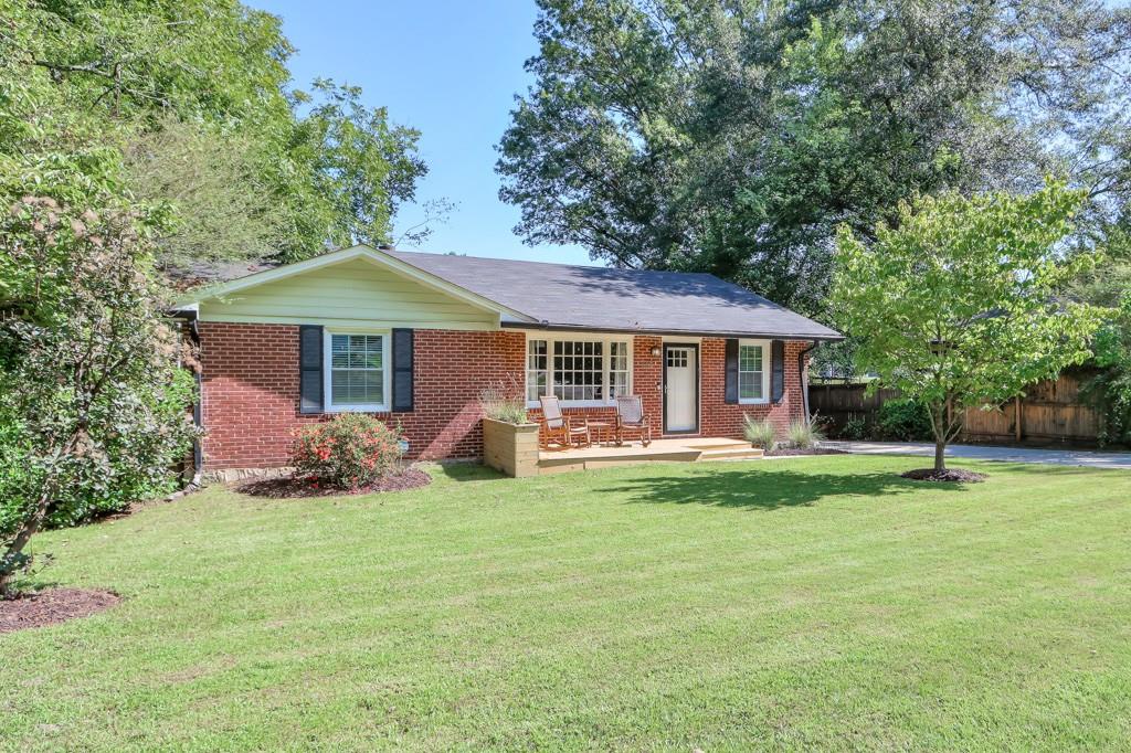 885 Scott Circle Decatur, GA 30033 - Photo 1 of 1 a front view of a house with a garden and trees