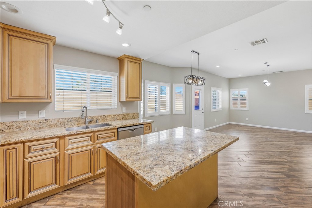 956 West Tibbot Street Rialto, CA 92377 - Photo 17 of 37 a kitchen with stainless steel appliances granite countertop a kitchen island a stove and a sink