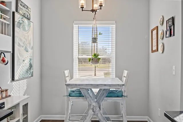 a dining room with furniture and window