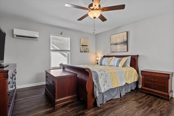 a bedroom with bed and wooden floor