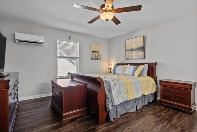 a bedroom with bed and wooden floor