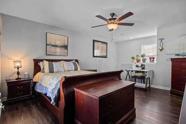 a bedroom with bed and wooden floor