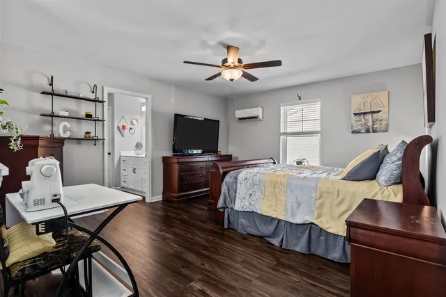 a bedroom with a bed and a tv