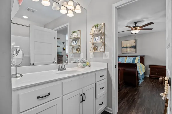 a bathroom with a sink a vanity and a mirror