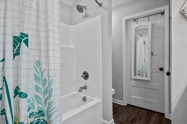 a bathroom with a bathtub and shower