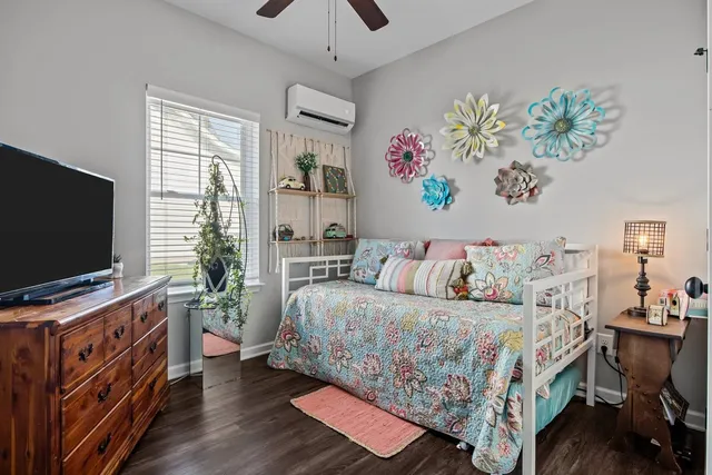 a bedroom with a bed and a flat screen tv