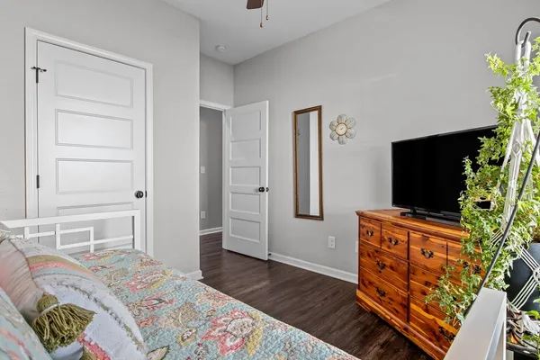 a bedroom with a bed and flat screen tv