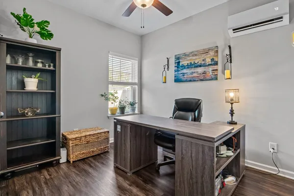 a view of a workspace with furniture and wooden floor