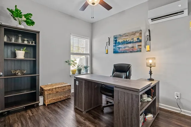 a view of a workspace with furniture and wooden floor