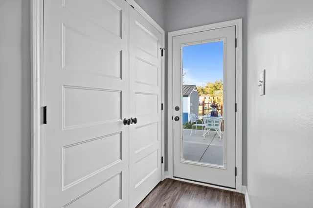 a view of a hallway with wooden floor