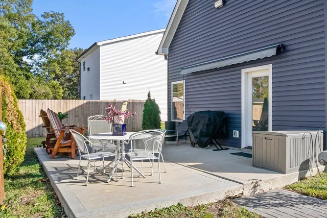 a view of a patio with table and chairs and potted plants