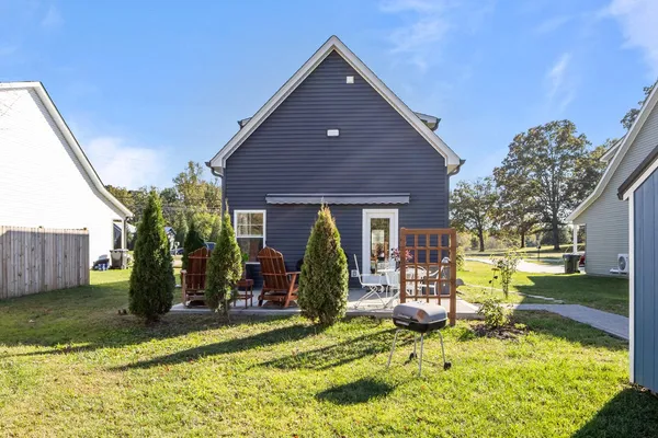 a view of a house with backyard porch and sitting area