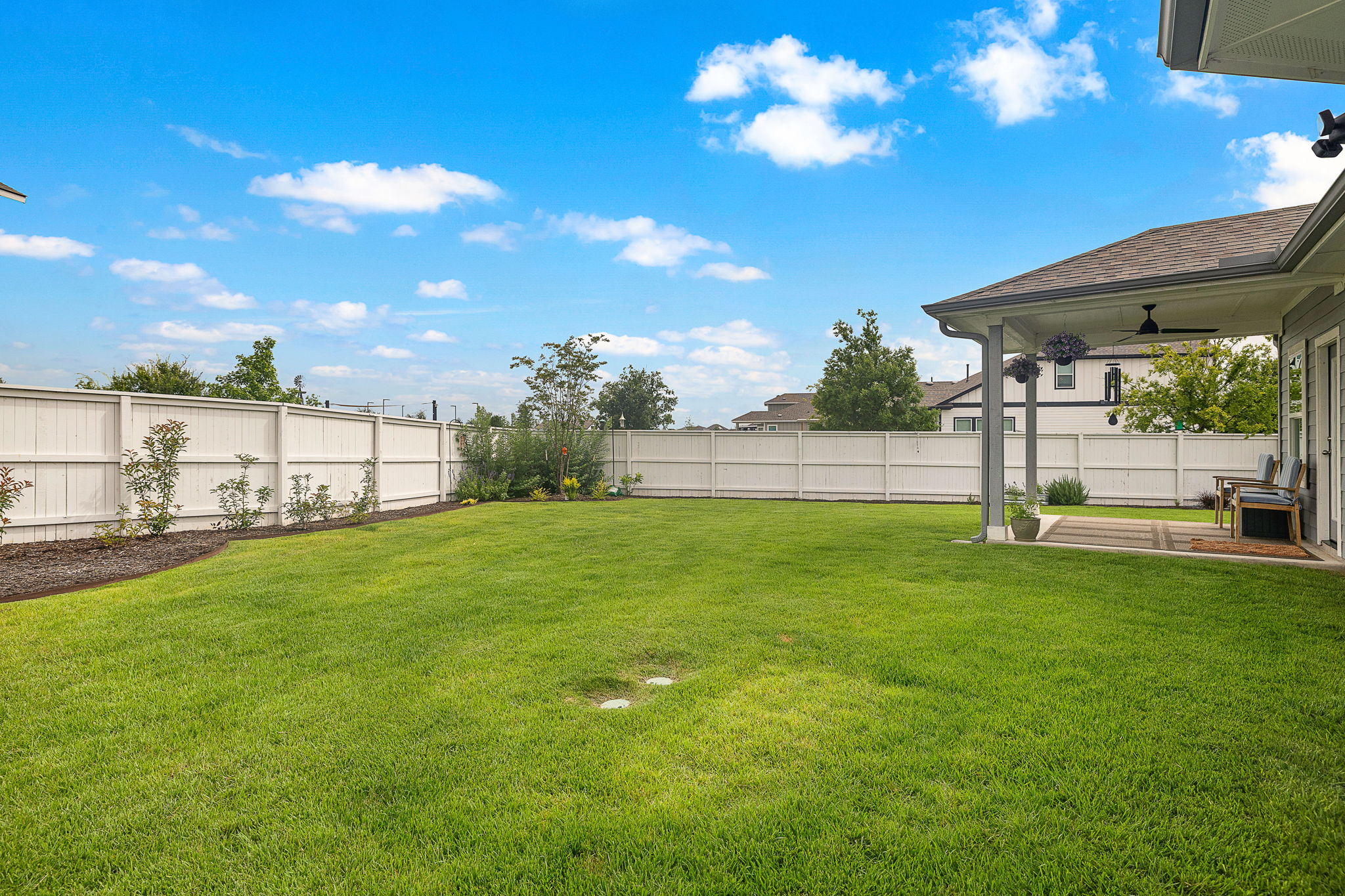 234 Appleberry Lane Elgin, TX 78621 - Photo 23 of 28 The patio looks out over a beautifully kept backyard.