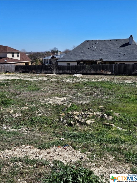 a view of a big yard with a house in the background