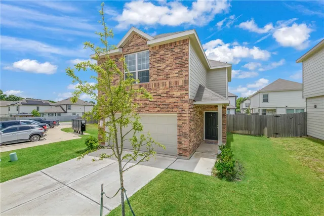 a backyard of a house with table and chairs