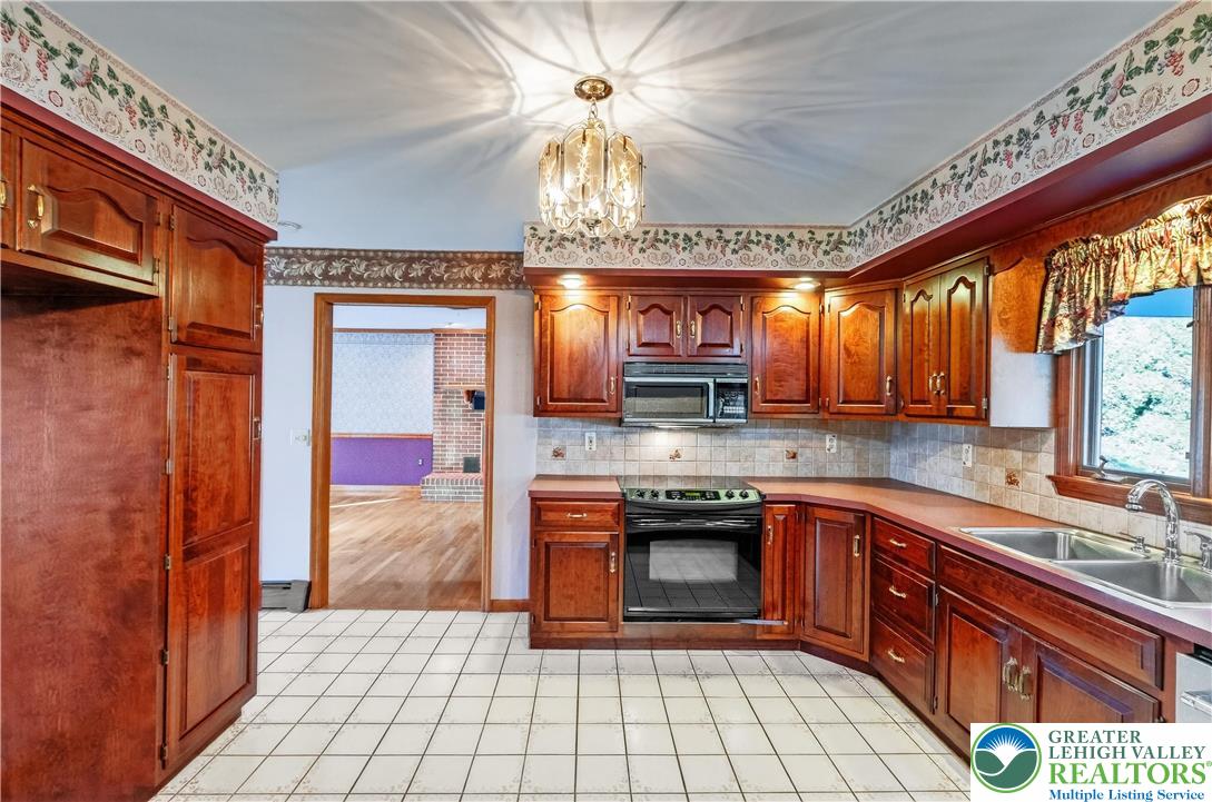 656 Daniels Road Nazareth, PA 18064 - Photo 14 of 54 a kitchen with stainless steel appliances granite countertop a stove cabinets and a sink