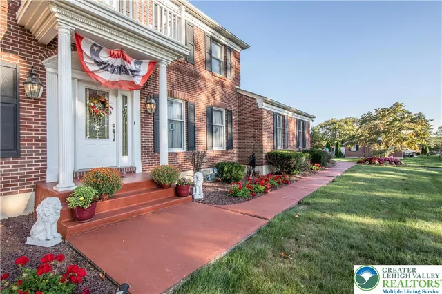 a front view of a house with a yard and outdoor seating