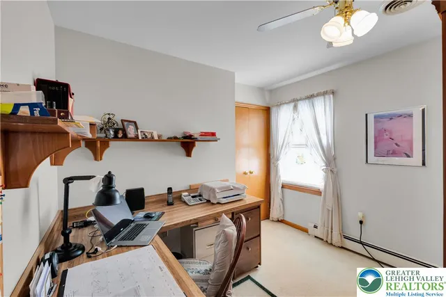 a living room with furniture a flat screen tv and a large window