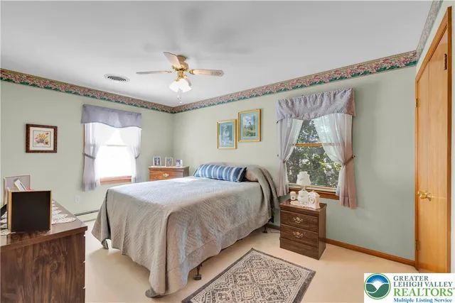 a living room with furniture a flat screen tv and a table