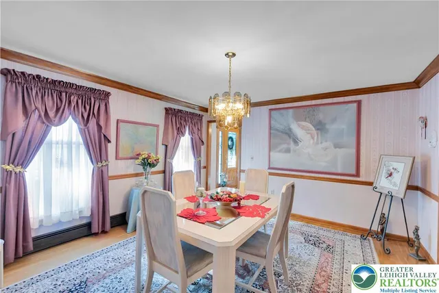 a dining room with furniture a chandelier and window