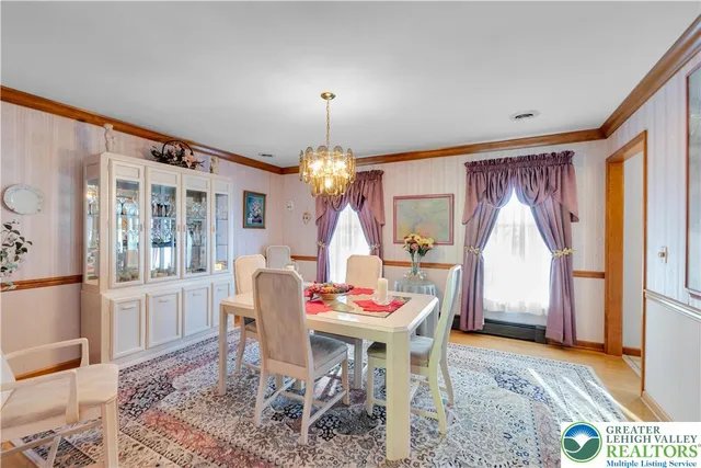 a dining room with furniture and a chandelier