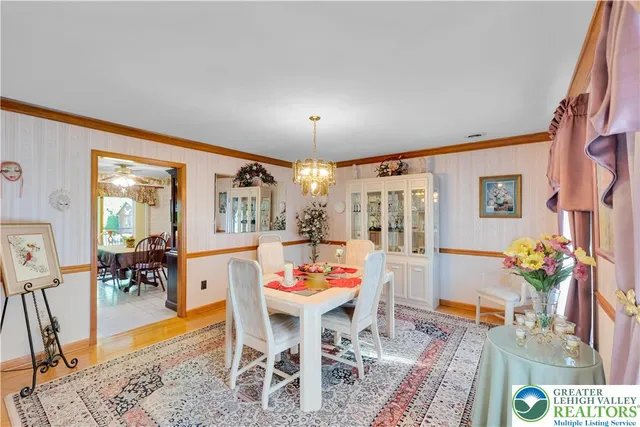 a outdoor dining room with furniture one side kitchen view and wooden floor