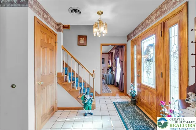 a living room with furniture a flat screen tv and a large window