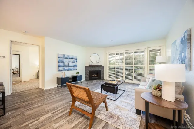 a living room with furniture a fireplace and a table
