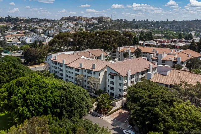 an aerial view of residential houses with outdoor space and river