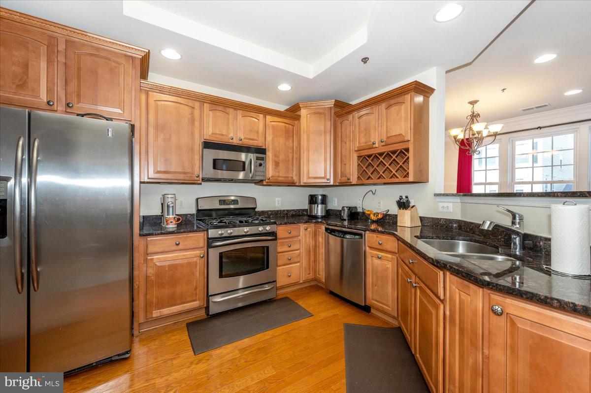 3541 Huntley Manor Lane, Unit 79B Alexandria, VA 22306 - Photo 12 of 40 a kitchen with stainless steel appliances granite countertop a stove a sink dishwasher a refrigerator and a microwave oven
