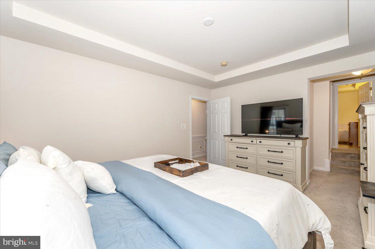 3541 Huntley Manor Lane, Unit 79B Alexandria, VA 22306 - Photo 20 of 40 a bedroom with a bed and a flat screen tv