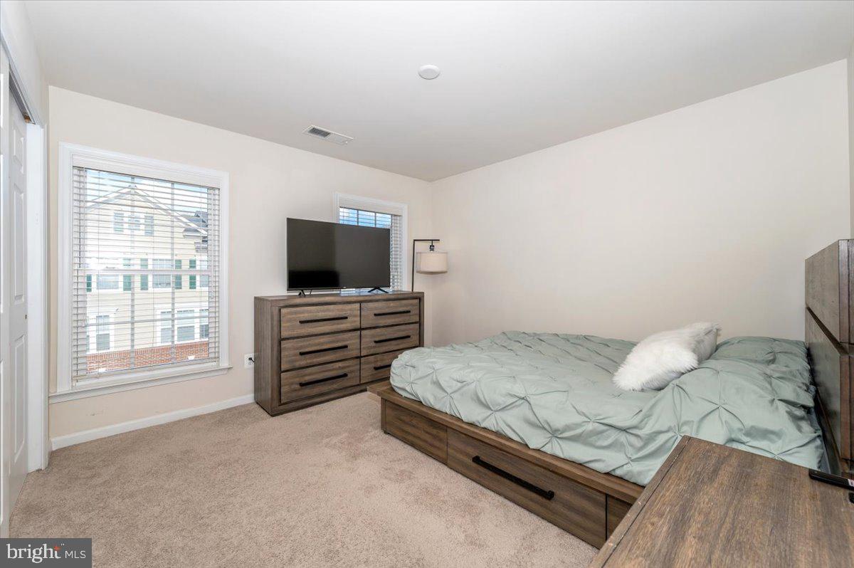 3541 Huntley Manor Lane, Unit 79B Alexandria, VA 22306 - Photo 23 of 40 a bedroom with a bed and flat screen tv