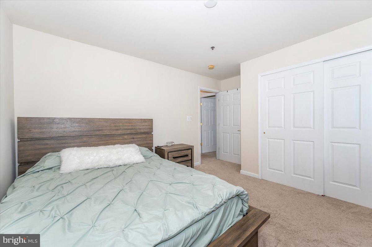 3541 Huntley Manor Lane, Unit 79B Alexandria, VA 22306 - Photo 24 of 40 a bedroom with a bed and a window