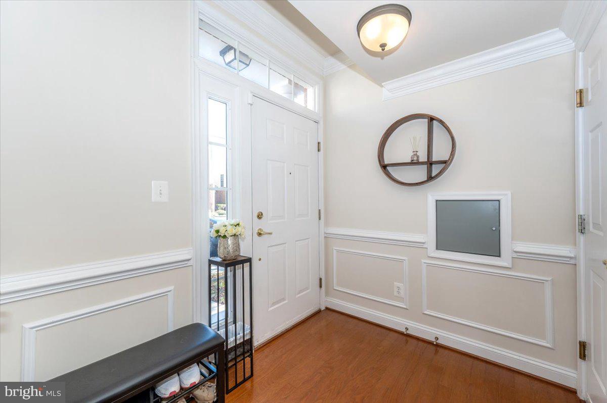 3541 Huntley Manor Lane, Unit 79B Alexandria, VA 22306 - Photo 3 of 40 a view of a livingroom with wooden floor and white cabinet